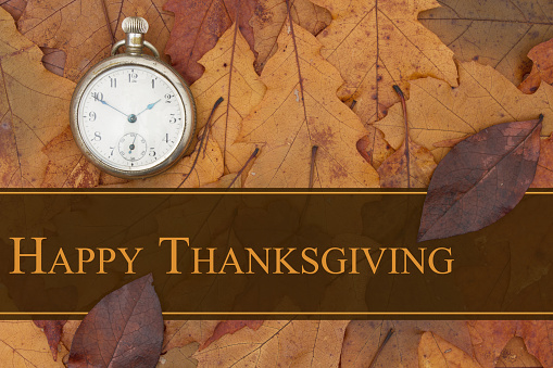 Happy Thanksgiving message, Some fall leaves and retro pocket watch with text Happy Thanksgiving