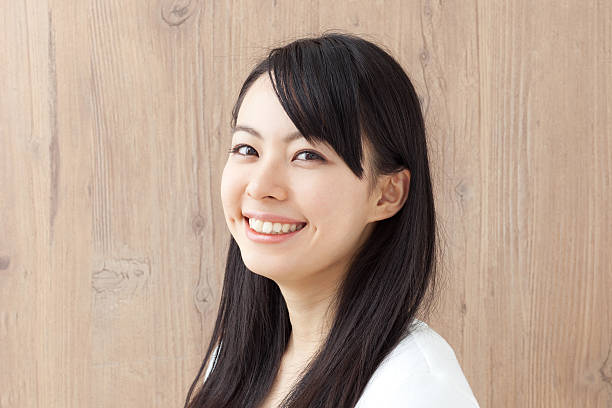 istock Japanese woman in front of grained wall 613034800