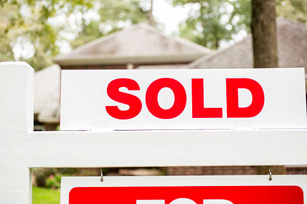 istock House for sale sign in front yard. 613035162