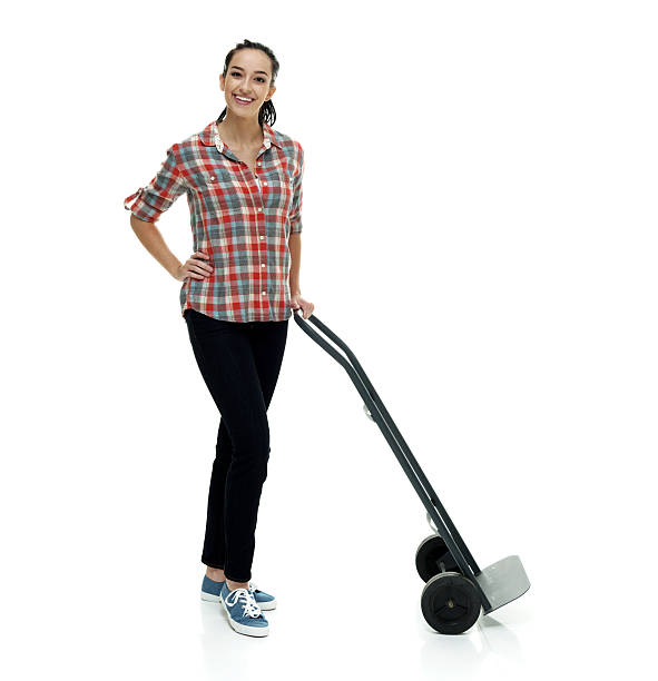 istock Cheerful female holding hand truck 613037298
