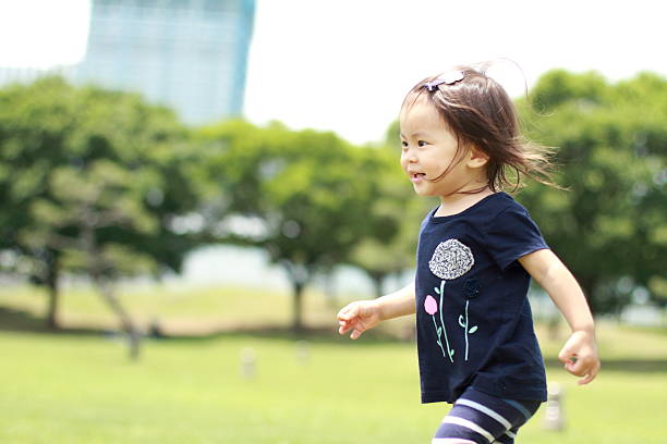 istock Japanese girl walking on the grass (1 year old) 613038854