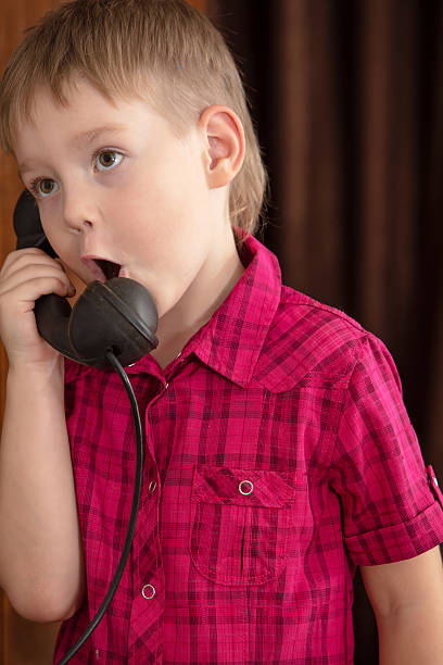 istock The boy says into the phone old 613039774
