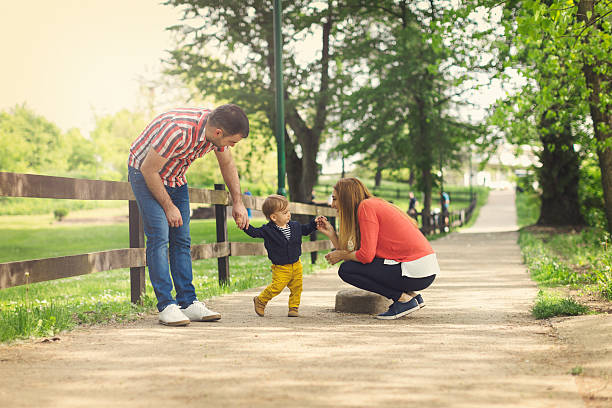istock Young parents and their baby boy learning to walk 613039782