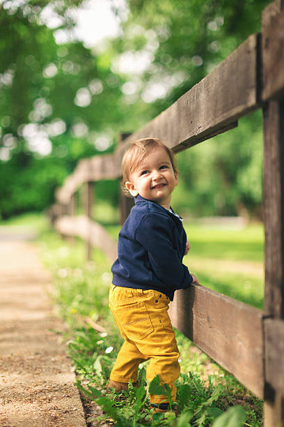 petit garçon faisant ses premiers pas - baby first steps autumn child photos et images de collection