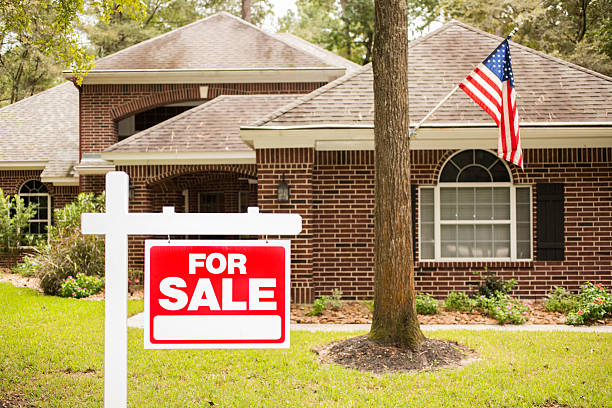 istock House for sale sign in front yard. 613040548