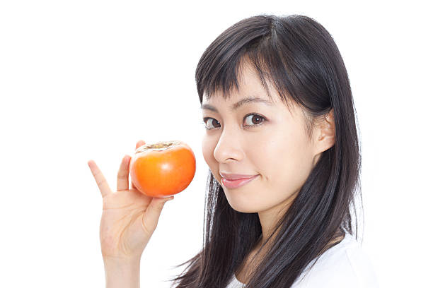 Japanese woman holding a kaki