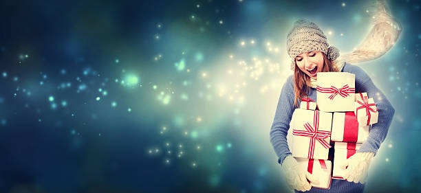 istock Happy young woman holding many present boxes 613041928