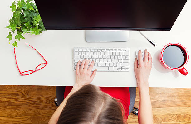 istock Woman working in her home office from above 613042056