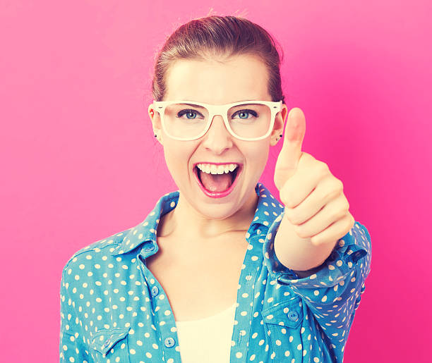 istock Happy young woman giving a thumb up 613042630