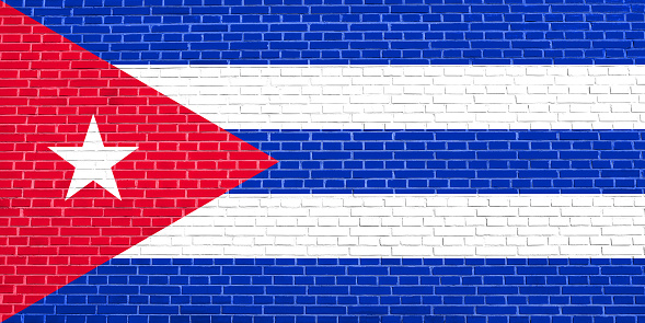 Cuban national official flag. Patriotic symbol, banner, element, background. Flag of Cuba on brick wall texture background