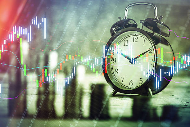 istock Alarm clock standing with coins-2.jpg 613044188