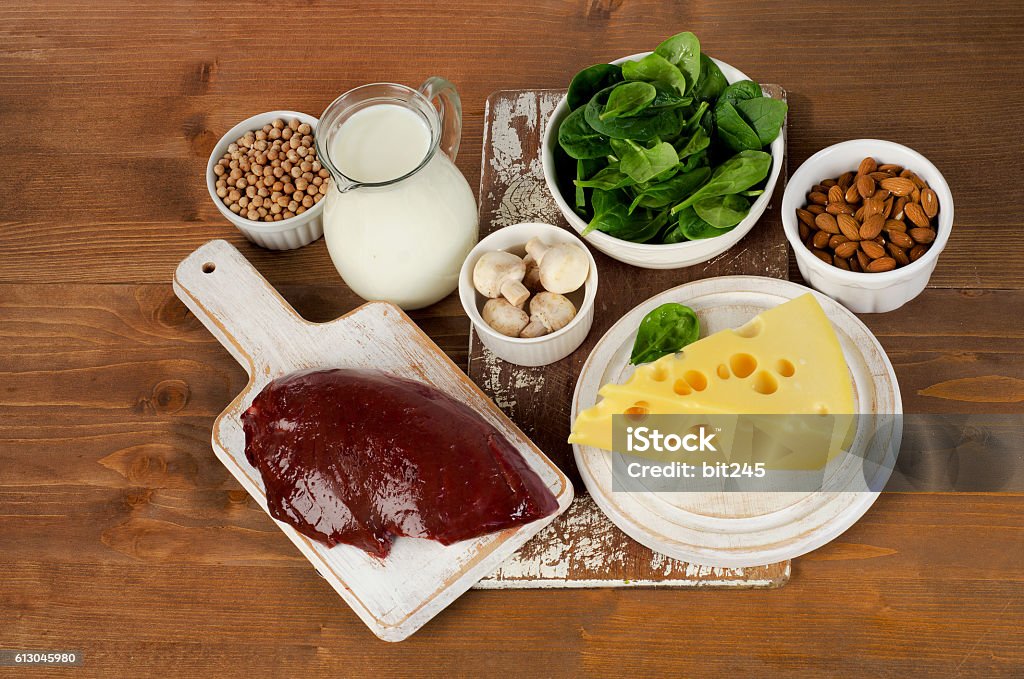 Food sources of vitamin B2 Food sources of vitamin B2 on wooden background. Healthy eating. View from above Animal Digestive System Stock Photo