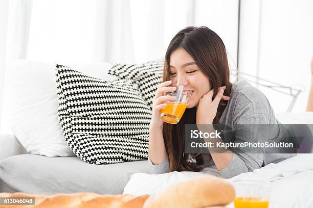 Asian Girl Drinking Juice Stock Photo - Download Image Now - Drinking, Juice - Drink, Women
