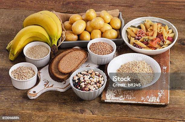 Foods High In Carbohydrate On Wooden Background Stock Photo - Download Image Now - Carbohydrate - Food Type, Raw Potato, Food