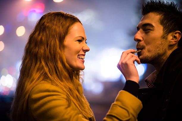 Sweet love - eating chocolate together - fotografia de stock