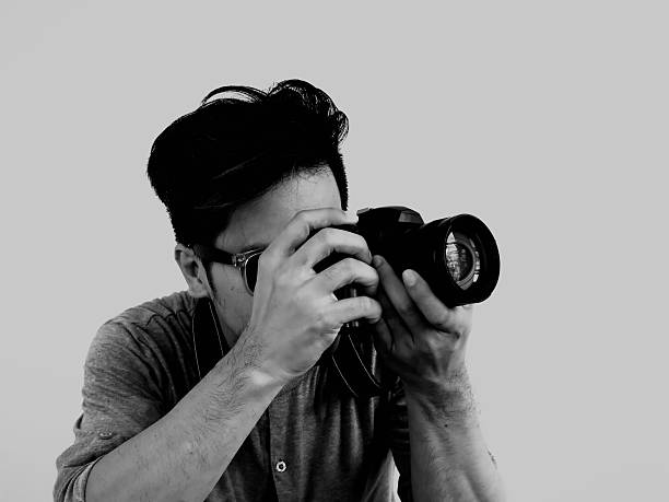 istock Man taking photo in black and white color tone 613048736