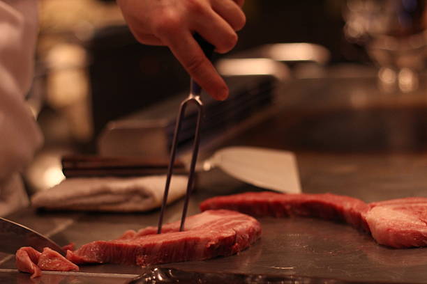 istock Chef is cutting Miyazaki steak to small pieces, Teppanyaki 613049510