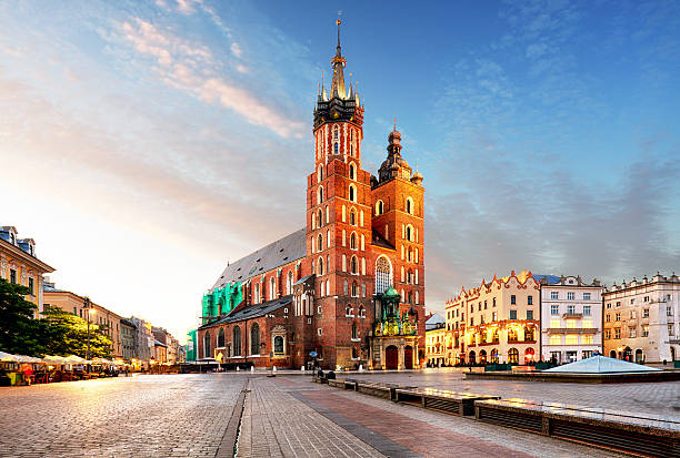 Old city center St. Mary's Basilica in Krakow Old city center view with Adam Mickiewicz monument and St. Mary's Basilica in Krakow krakow stock pictures, royalty-free photos & images