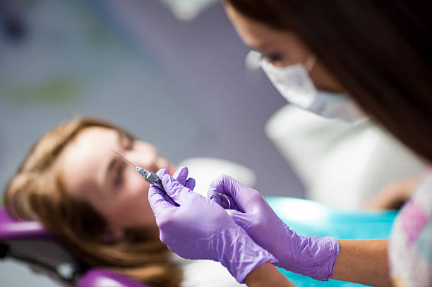 istock Dentist curing a child patient in the dental office 613050594