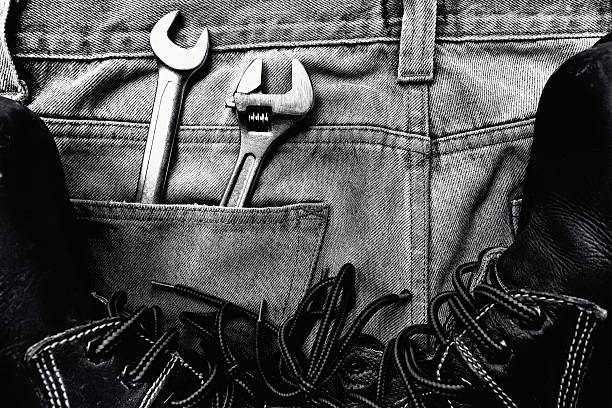 Black and white Wrenches on jeans stock photo