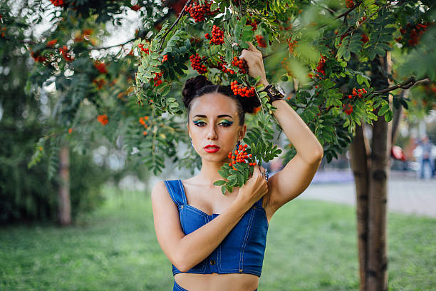 istock Beautiful young woman with rowan berries 613053792