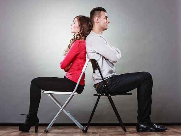 istock Young couple after quarrel sitting back to back 613054794