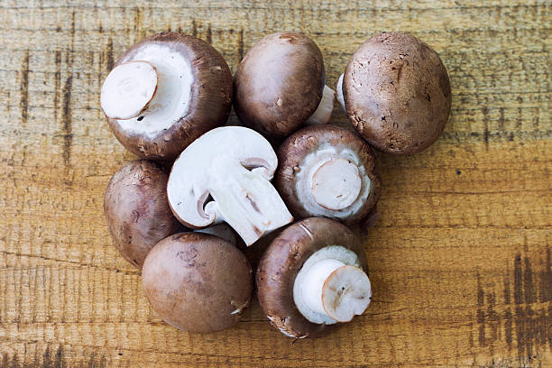 istock fresh mushrooms on wodden background 613056442