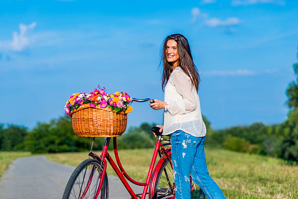 istock Young girl with a bicycle 613057896