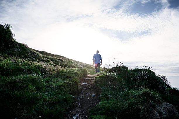 istock man walking along coastal footpath, Newquay, Cornwall, Autumn. 613101816
