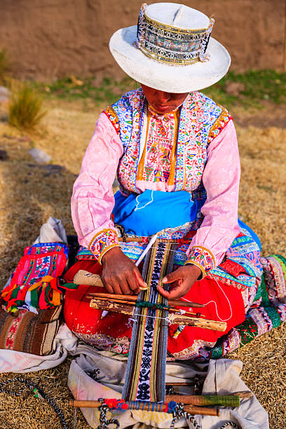 istock Peruvian woman weaving near Colca Canyon, Peru 613102966