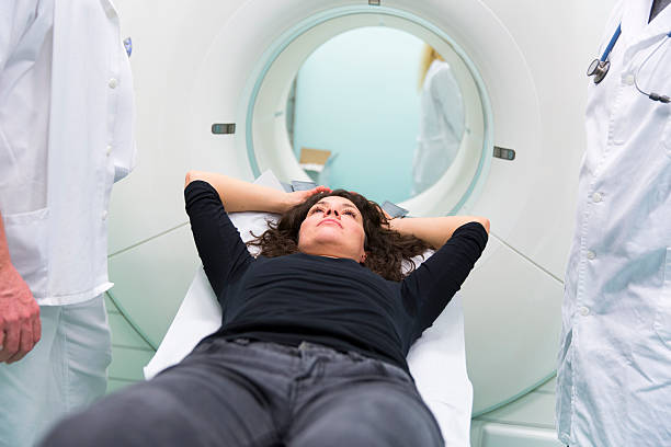 istock Chief radiologist,young doctor and  patient,having PET scan 613103276