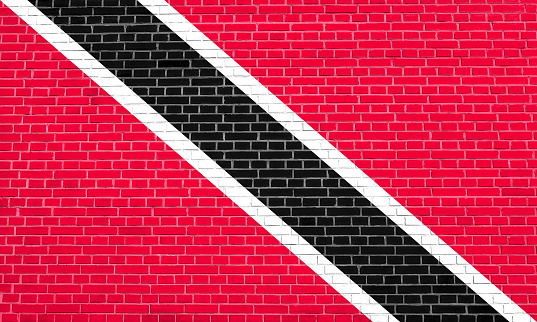 Trinidadian and Tobagonian national official flag. Patriotic symbol, banner, element, background. Flag of Trinidad and Tobago on brick wall texture background