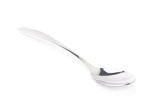 istock Stainless steel dessert spoon isolated 613107350