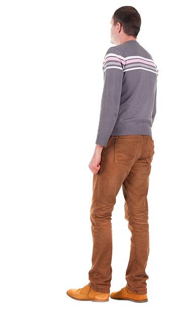 istock Back view of going  handsome man in jeans and sweater 613108832