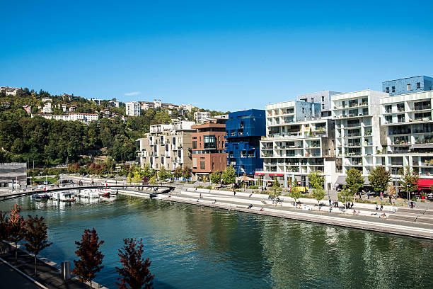 Lyon, France - October 4, 2016: famous Confluence District with people in Lyon, France with river. The architecture is famous for modern style.