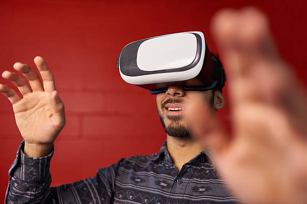 Millennial Indian man exploring space with virtual reality glasses in