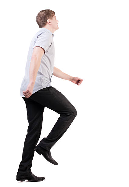 istock back view of running business man . 613114208