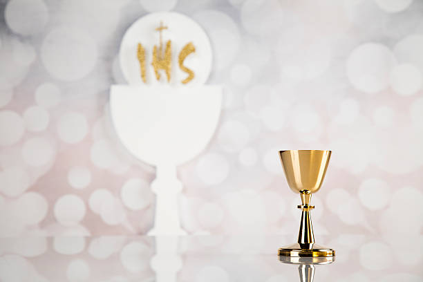 istock Holy communion a golden chalice, composition isolated on white 613114322