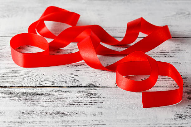 istock Shiny red ribbon on white background 613114596