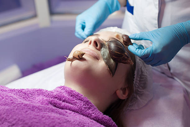 istock Snail on woman face 613115240