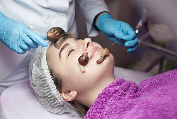 istock Snail on woman face 613115666