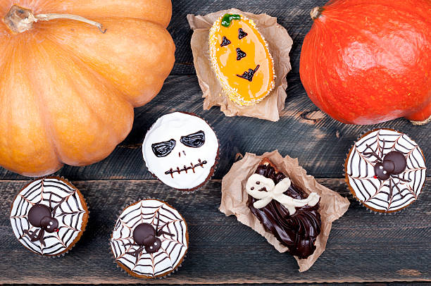 istock Halloween background. Pumpkin and funny muffins and cakes 613117310