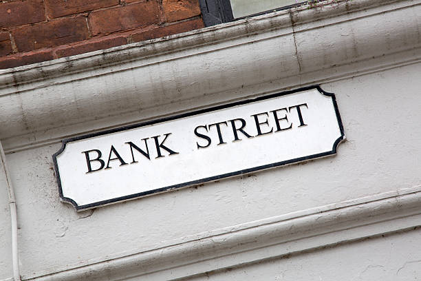 istock Bank Street on White and Brick Wall 613118130