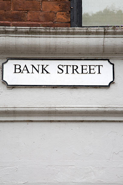istock Bank Street on White and Brick Wall 613118190