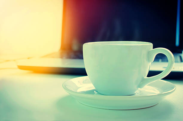 istock Laptop and a cup of coffee on a table 613119528