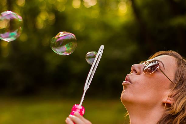 istock Young women blowing bubbles 613121234