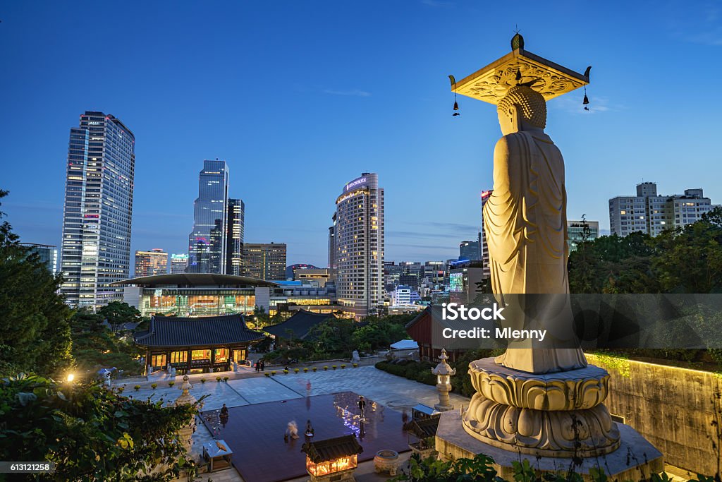 Bongeunsa Temple Seoul Modern Buildings at Night South Korea Famous Bongeunsa Temple Buddha Statue at Night - Twilight. Modern Skyscrspers of downtoen Seoul illuminated in the background. Half aerial view from the jungle behind the temple.  Seoul Stock Photo