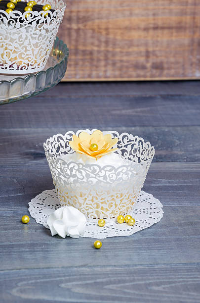 istock wedding gold and black cupcakes in lace wrappers 613123110