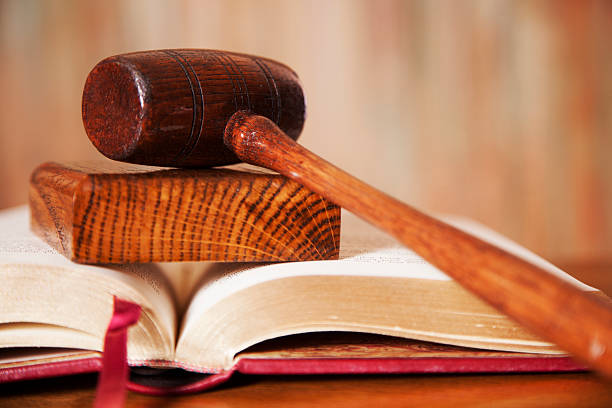 istock Judge's gavel with book on court room table. 613125674