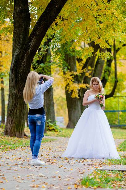istock Wedding photographer is taking pictures the bride 613128828